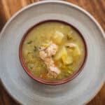 Creamy chicken vegetable soup with potatoes, peas, and shredded chicken served in a bowl. Perfect comfort food for cold days, easy to prepare, and packed with nutritious ingredients.