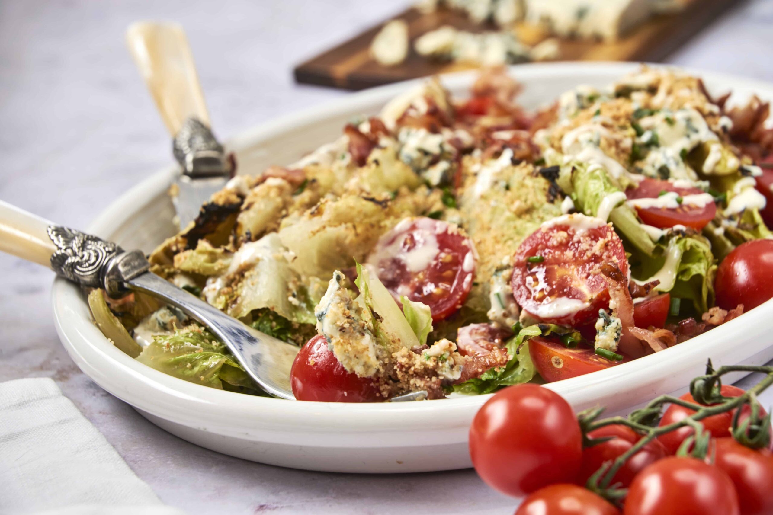 Golden-brown vegetable and cheese casserole on white dish with cherry tomatoes and fresh herbs, served with a fork, vibrant and appetizing, perfect comfort food.