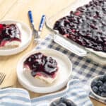 Sweet blueberry cheesecake dessert with fresh blueberries on top, served in white ramekins on a wooden table, perfect for summer dessert recipes and healthy snack options.