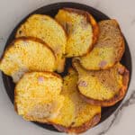 Fluffy, golden baked egg muffins with ham in a black dish, served as a delicious breakfast or brunch option. Perfectly cooked with a light, airy texture, ideal for meal prep or weekend mornings.