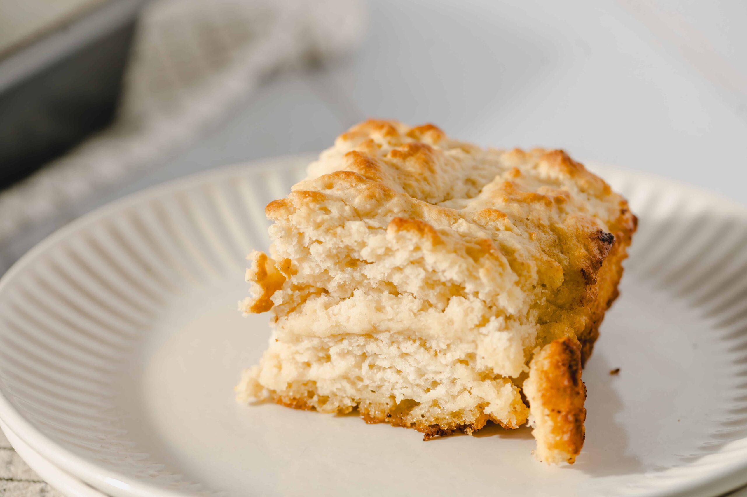 Buttermilk Biscuit with Butter and Honey - close-up of freshly baked fluffy buttermilk biscuit with golden crust, served on a white ceramic plate, perfect for breakfast or brunch, showcasing delicious comfort food.