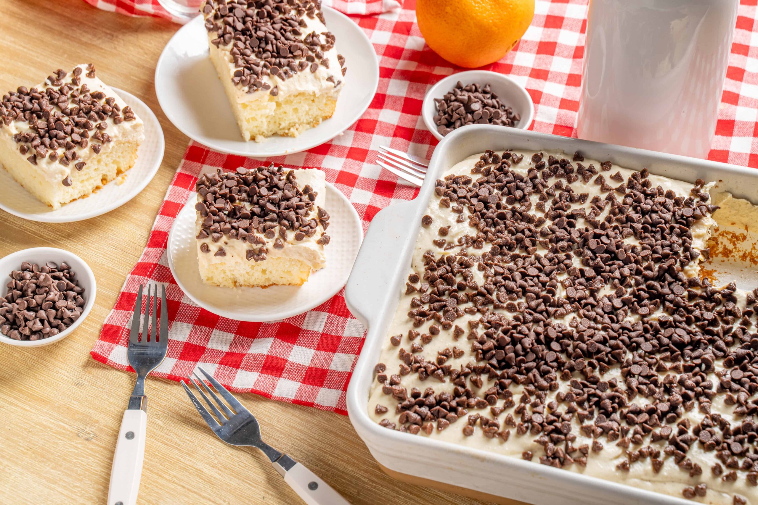 Creamy vanilla dessert with chocolate chips on top served in a baking dish and individual plates, perfect for baking and dessert recipes.