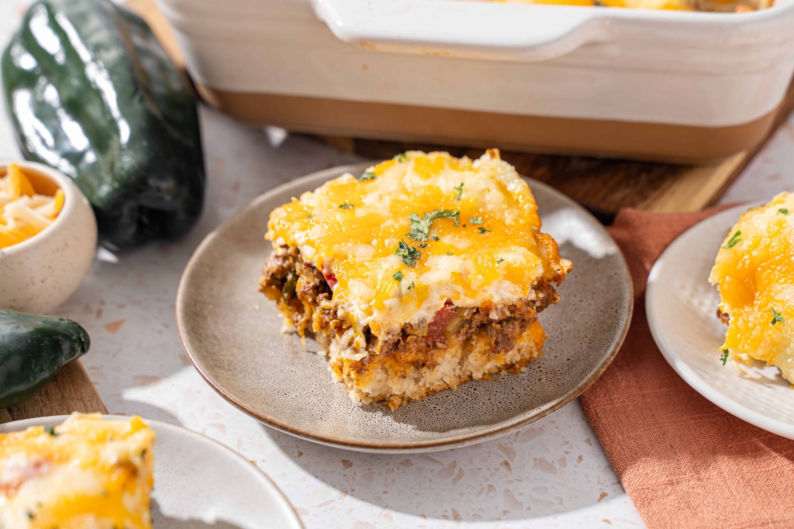 Creamy beef and cheese casserole with golden mashed potatoes and herbs, served on a rustic plate, perfect for comfort food and family dinners.