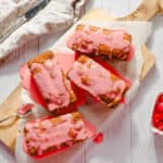 Sweet cherry loaf cakes with pink glaze on wooden cutting board, fresh cherries in white bowl, spring dessert, and homemade baking, perfect for spring desserts and cherry recipes.