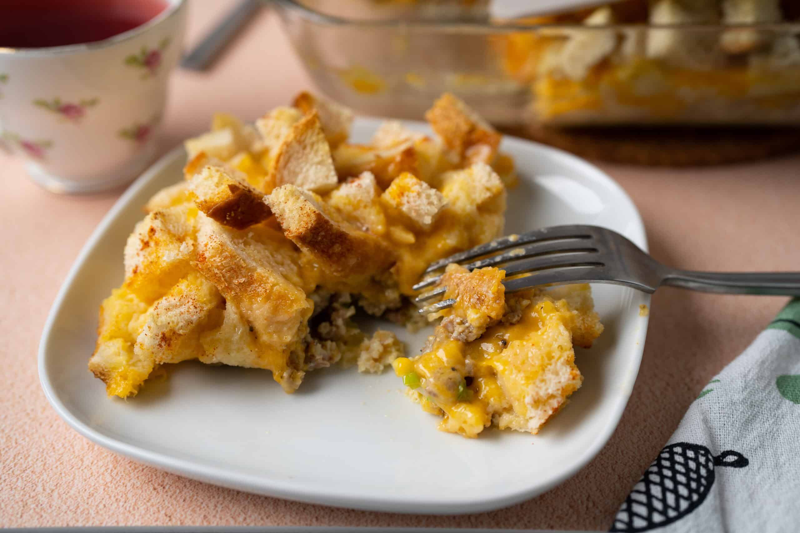 Buttermilk Pie dessert served on a white plate with a fork, with a slice broken off showing creamy custard filling, yellow crust, and crumbled topping, cozy dessert presentation.