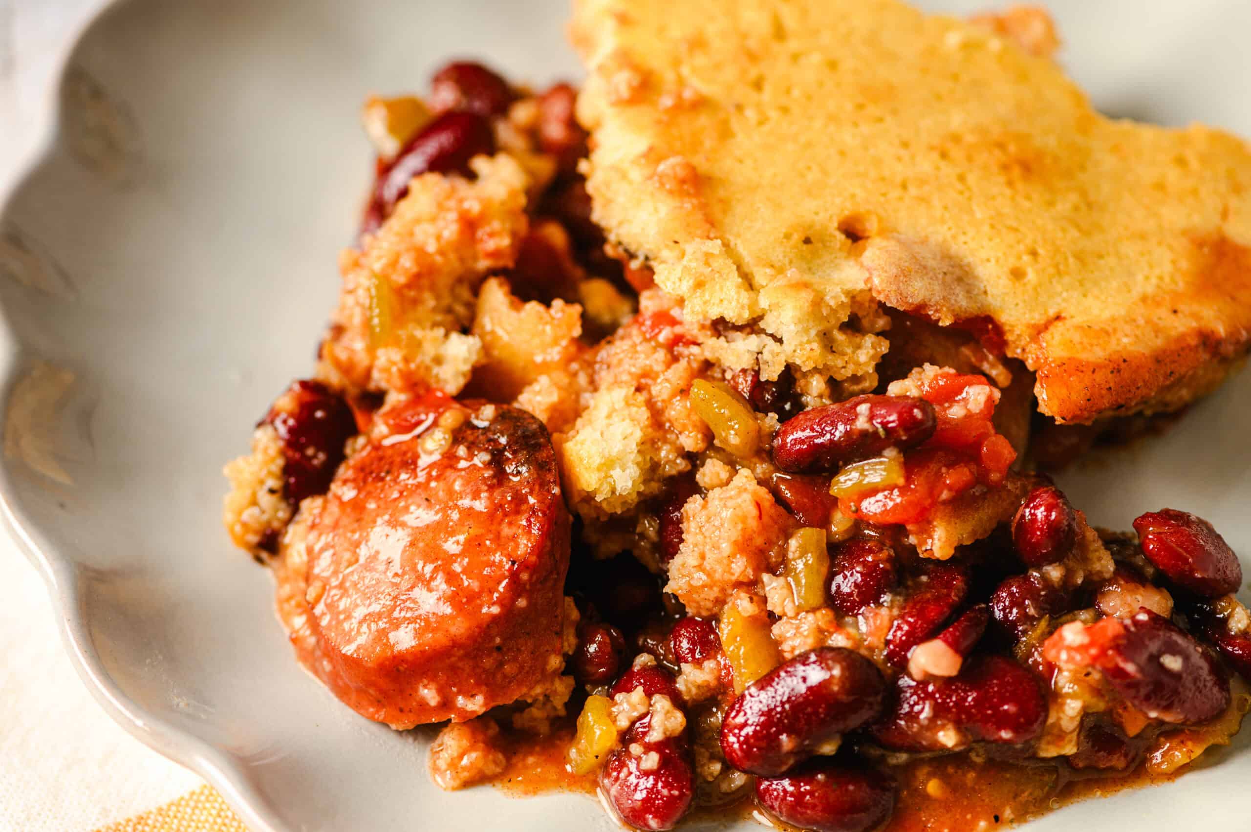 Hearty homemade chicken pot pie with crust, served with a flavorful side of seasoned beans and vegetables, making a comfort food meal perfect for family dinners.