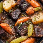 Tender beef stew with carrots, potatoes, celery, and herbs in a savory broth, served in a rustic bowl for hearty comfort food. Perfect for slow-cooked, family-friendly dinners.
