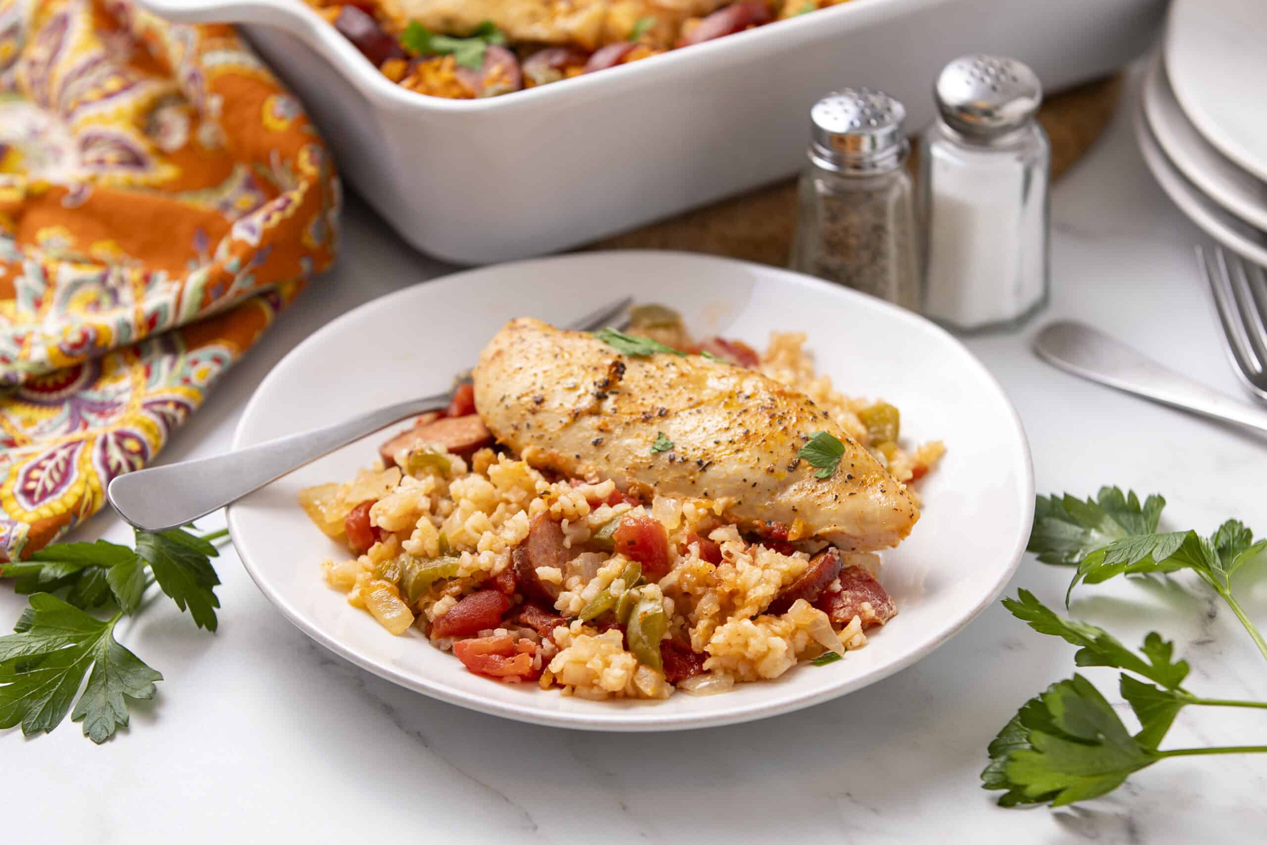 Juicy baked chicken breast served over flavorful rice and vegetable medley, perfect for a healthy and satisfying meal. Fresh herbs and colorful ingredients create an appetizing and nutritious dinner option.
