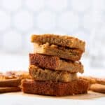 Cookies stacked on a wooden surface, showcasing different flavors and textures, with a white background and cinnamon sticks, perfect for easy homemade cookie recipes and baking ideas.