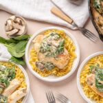 Creamy mushroom and spinach chicken breast served over egg noodles with fresh herbs and a mushroom sauce.