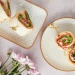 Fresh veggie pinwheel sandwiches on decorative plates, perfect for healthy snacks or parties. Colorful, creamy, and delicious, these roll-ups feature crisp lettuce, cold cuts, and cheese in a soft wrap.