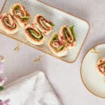 Fresh veggie and cheese wraps on skewers served on decorative plates, healthy and colorful meal ideas, perfect for snacks or appetizers.