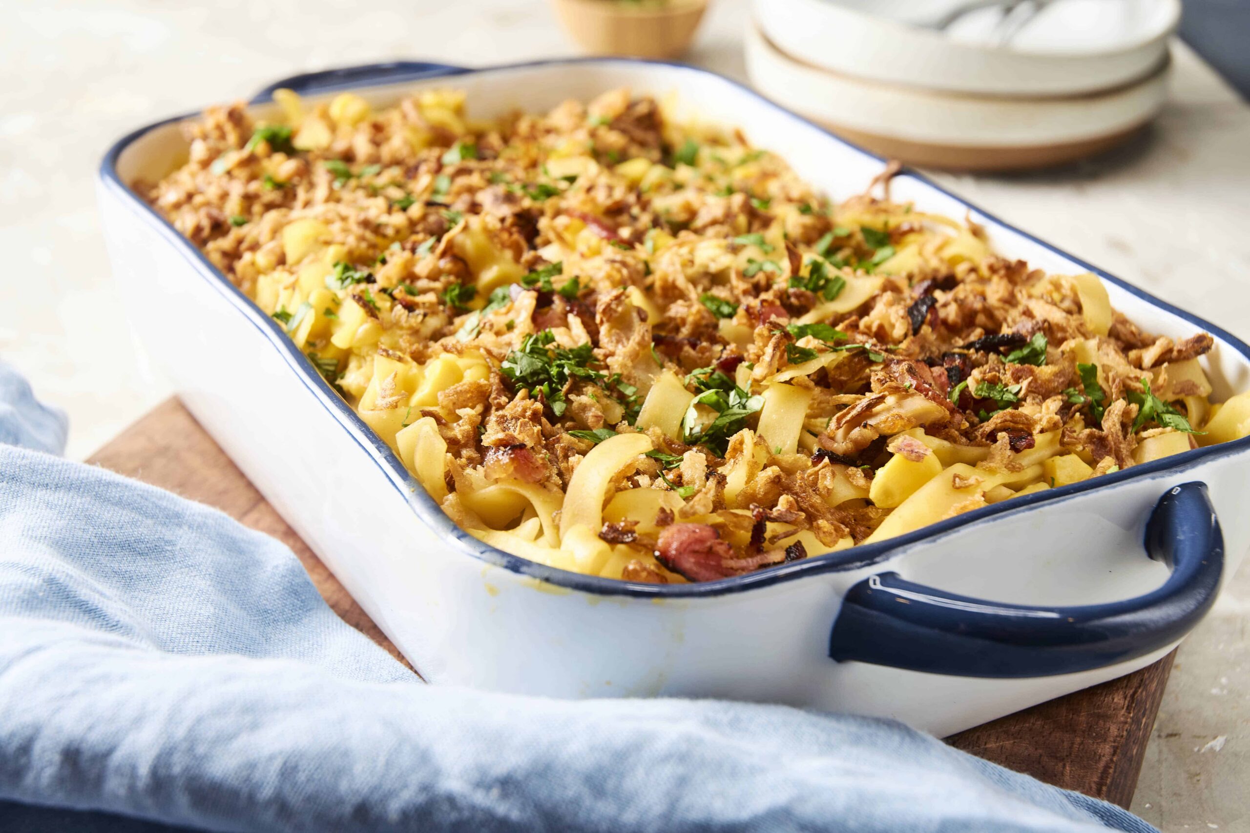 Savory baked pasta casserole with ground meat, cheese, and herbs in a white and blue baking dish for a comforting meal.