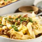 Creamy pasta carbonara with crispy bacon, chopped parsley, and grated cheese served in a rustic bowl, perfect for a comforting Italian dinner at home.