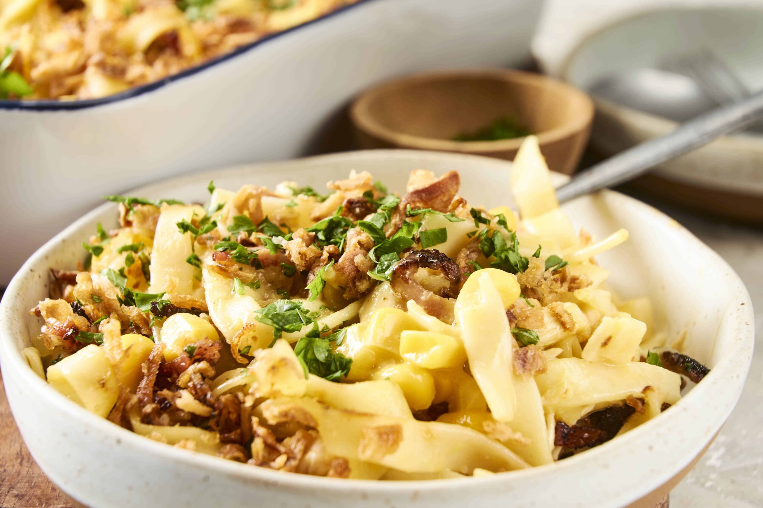 Creamy pasta carbonara with crispy bacon, chopped parsley, and grated cheese served in a rustic bowl, perfect for a comforting Italian dinner at home.
