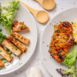 Roasted chicken with salad and corn mashed potatoes on white plates, healthy dinner meal, grilled chicken with herbs, fresh mixed greens, creamy mashed potatoes with corn, nutritious home-cooked dish, Hey Recipe.