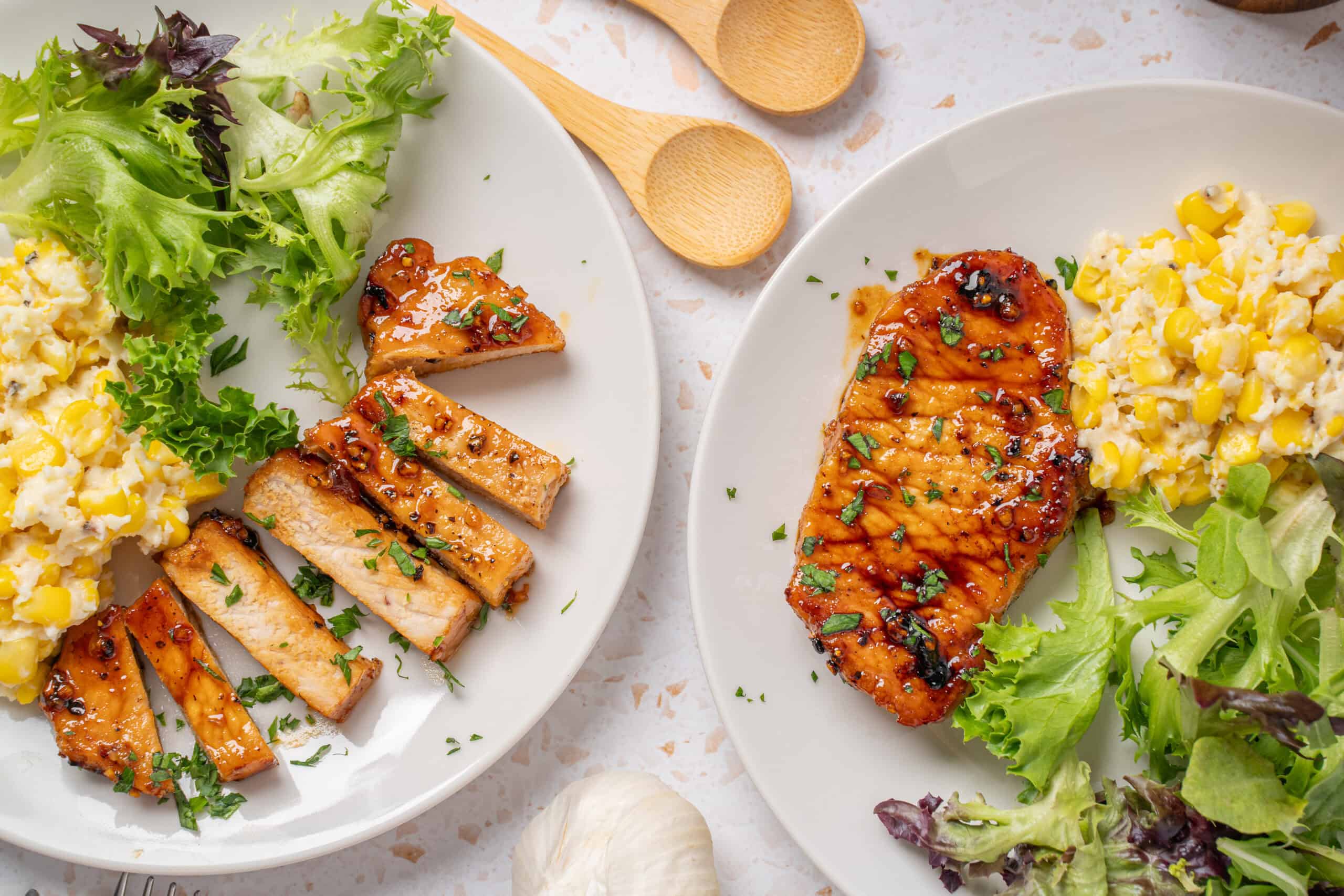 Roasted chicken with salad and corn mashed potatoes on white plates, healthy dinner meal, grilled chicken with herbs, fresh mixed greens, creamy mashed potatoes with corn, nutritious home-cooked dish, Hey Recipe.