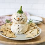 Cream cheese snowman with cracker snacks, holiday appetizer, festive Christmas appetizer, cheese ball snowman, holiday party snack, cheese ball decoration, easy holiday appetizer, cheese ball gingerbread man, Christmas party finger food, cheese appetizer with crackers.