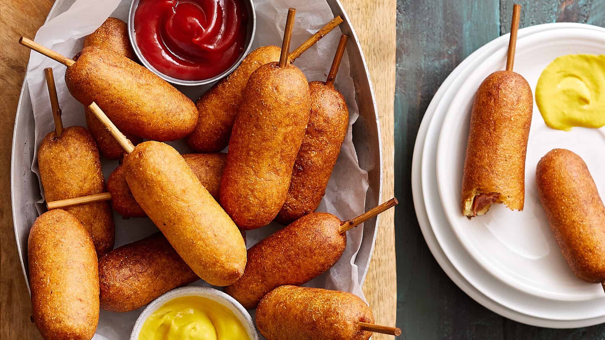 Crispy mozzarella sticks served with ketchup and mustard dipping sauces on a rustic wooden tray, perfect for appetizer or snack ideas, highlighting comfort food, crunchy exterior, and cheesy interior.