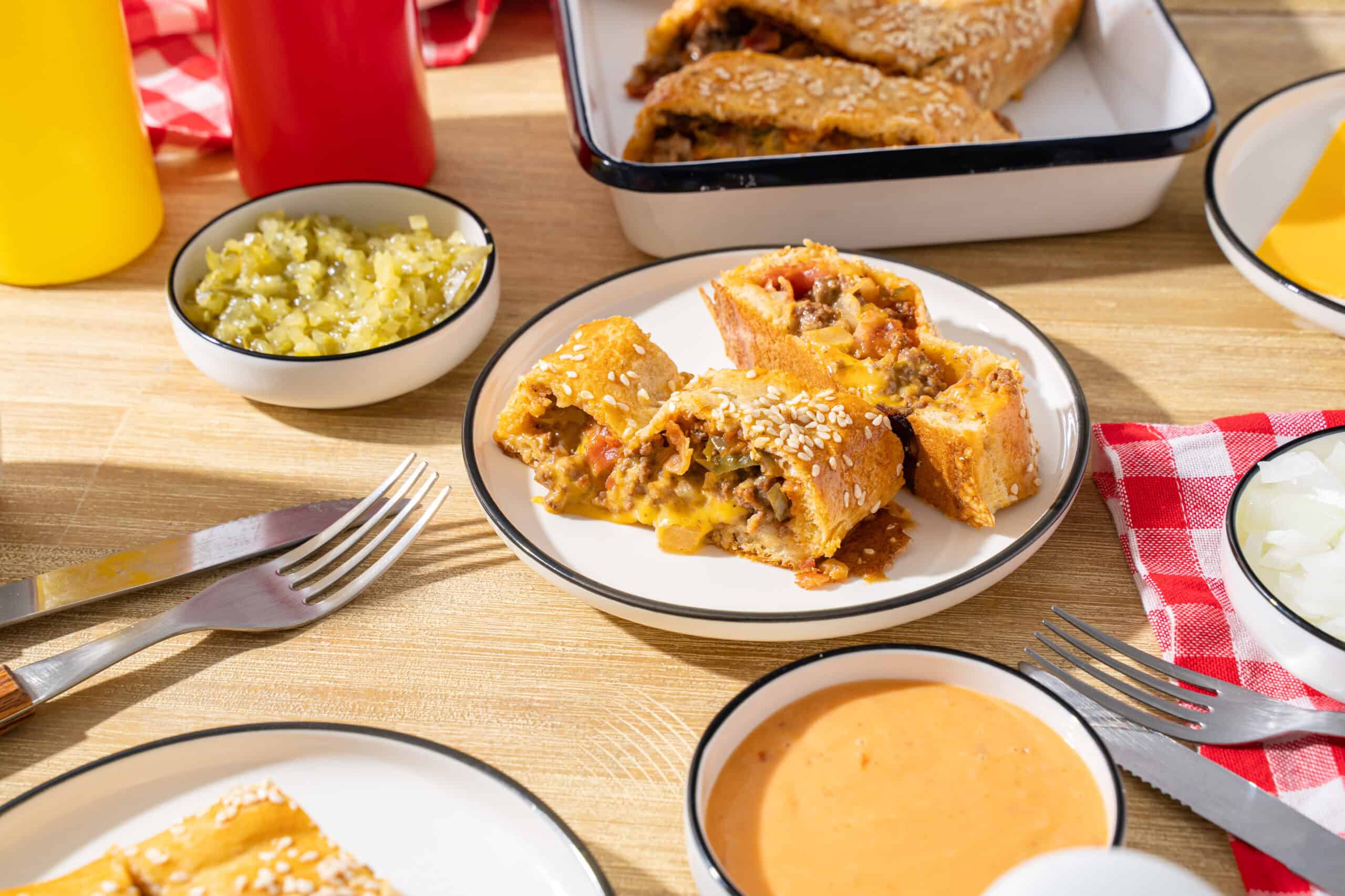 Savory Mexican beef and bean flautas served with toppings and side dishes, featuring crispy rolled tortillas filled with seasoned meat, cheese, and vegetables, on a rustic wooden table.