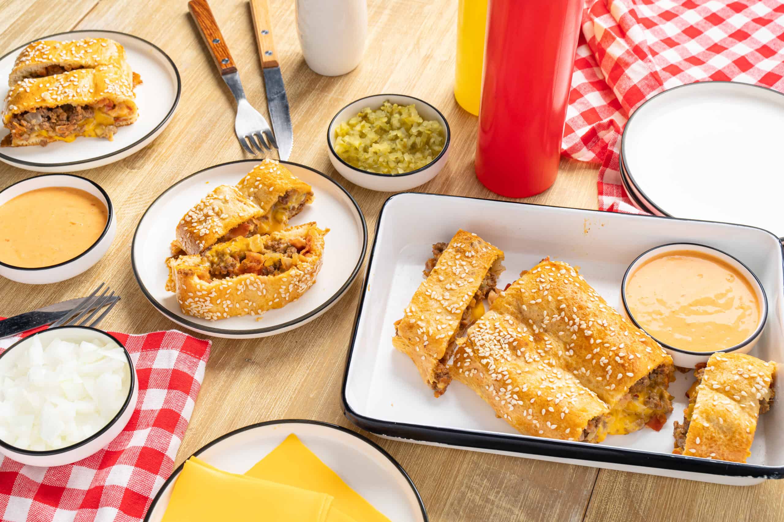 Golden burritos with beef, cheese, and vegetables served with creamy cheese sauce and fresh toppings on a wooden table. Perfect for quick, delicious Mexican-inspired meals.
