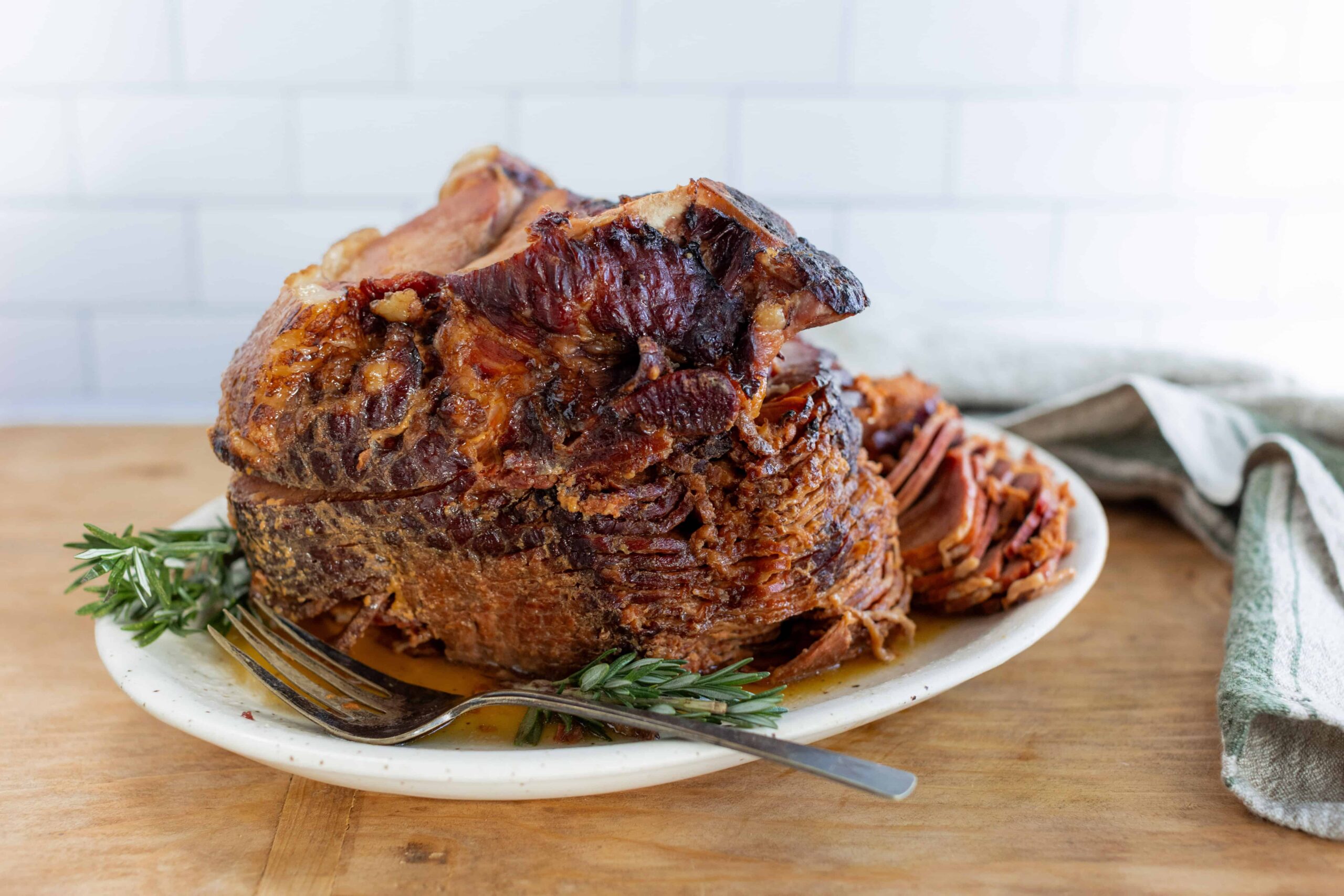 Succulent pot roast beef cooking in flavorful gravy, served on a white plate with fresh herbs and a fork. Perfect for hearty family dinners or special occasions, showcasing tender, slow-cooked meat.