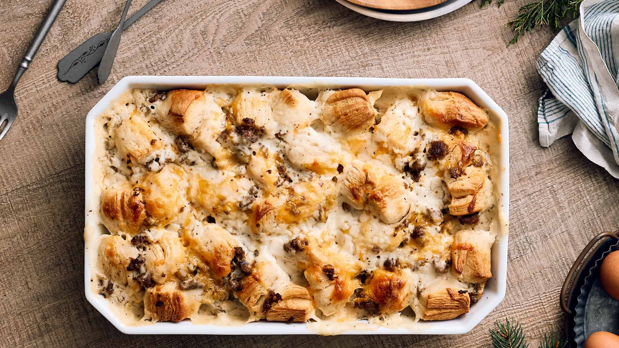Creamy chicken alfredo casserole with tender chicken, mushrooms, and melted cheese baked to golden perfection in a white serving dish. Perfect comfort food for family dinners or special occasions.