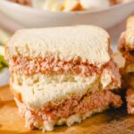 Buttered ham and cheese breakfast sandwich on white bread, close-up, for breakfast recipes and comfort food imagery.