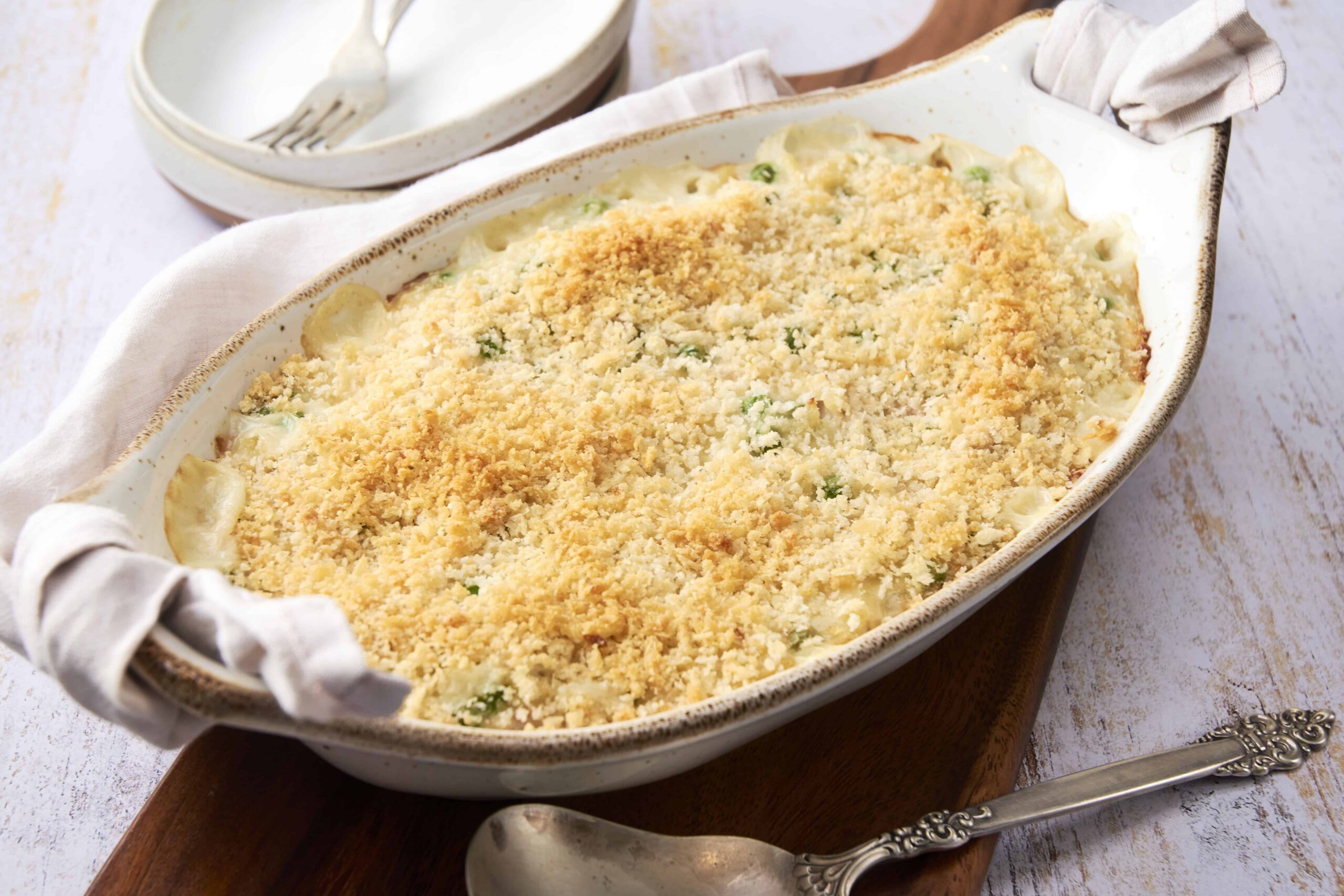 Creamy baked pasta casserole with a crunchy breadcrumb topping and melted cheese, served in an oval ceramic dish. Perfect comfort food recipe for sharing.