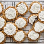 Soft oatmeal cookies topped with white icing and decorative sprinkles, perfect for holiday treats or festive occasions. Baked to golden perfection, these cookies are a delightful sweet snack.