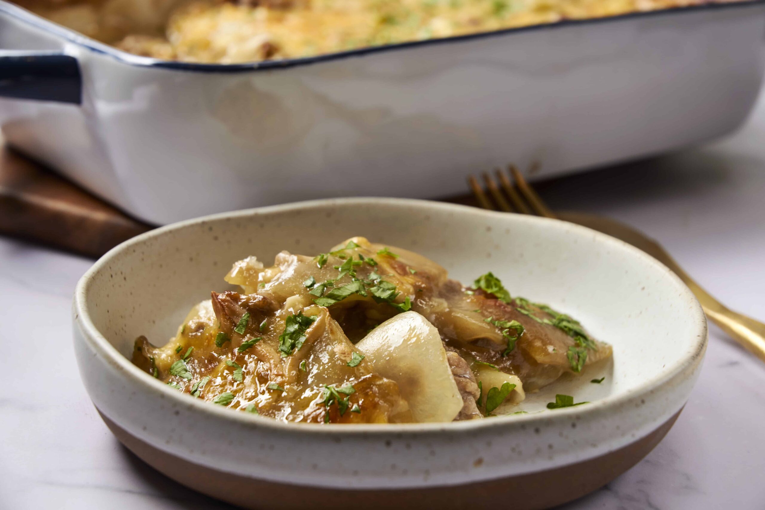 Slow cooker beef stew with tender beef chunks, potatoes, carrots, and peas in rich gravy garnished with chopped parsley. Perfect comfort food for chilly days, easy to make in a slow cooker.