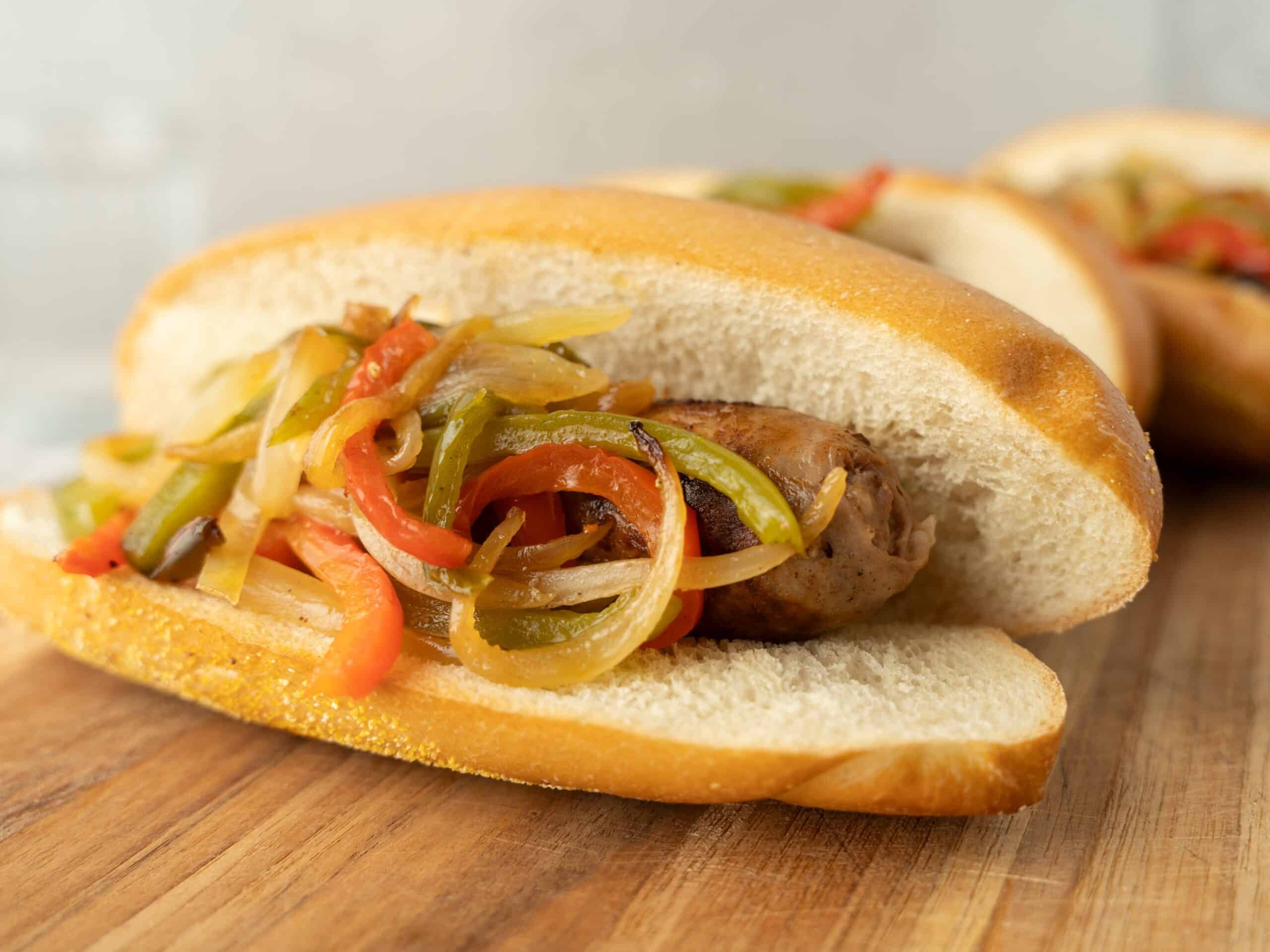 Sauteed bell peppers and onions stuffed inside a toasted hot dog bun, perfect for making delicious hot dogs with colorful vegetable toppings.