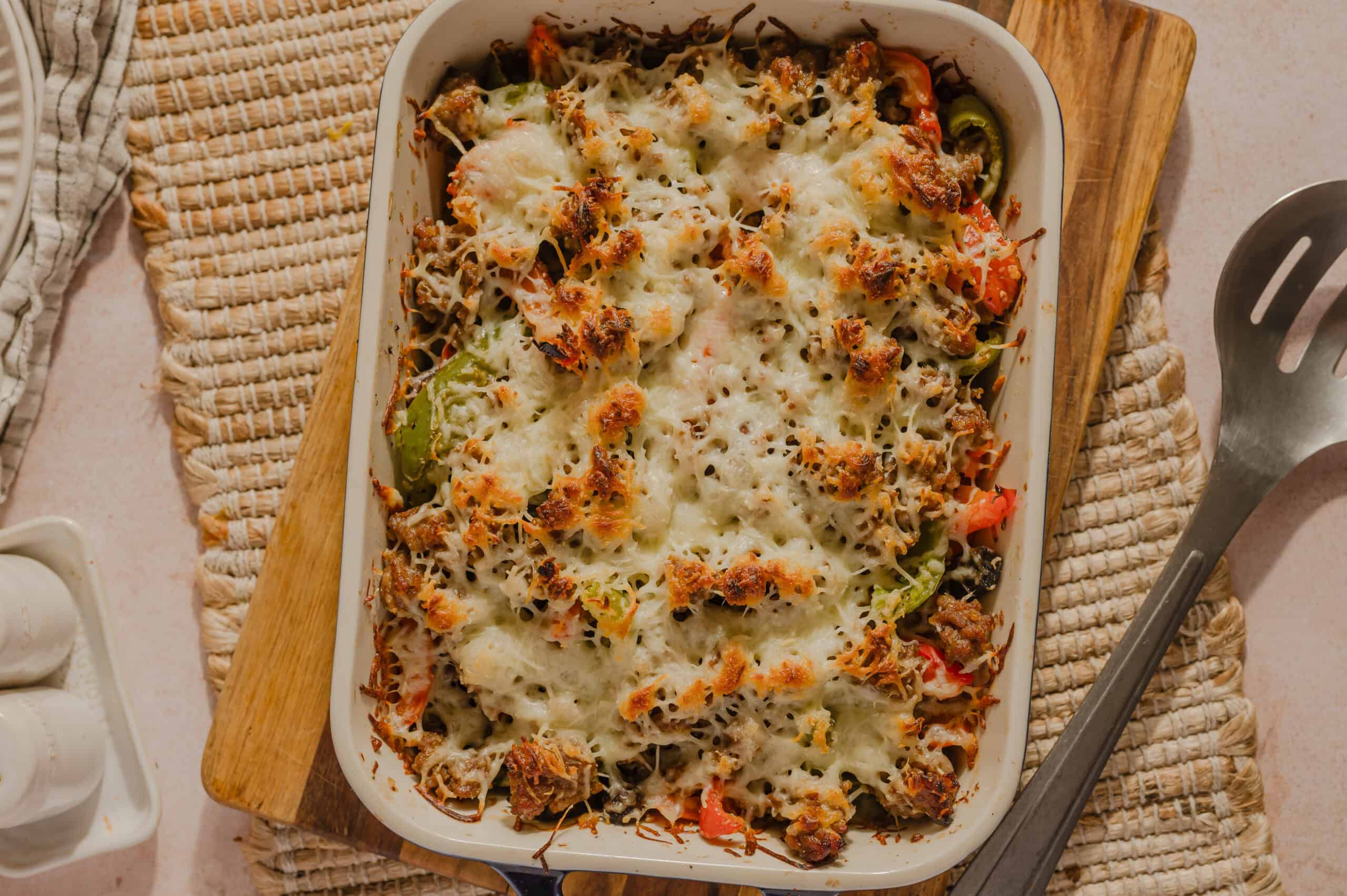 Creamy baked beef and vegetable casserole with melted cheese, perfect for a hearty family dinner. Deliciously loaded with seasoned ground beef, colorful peppers, and savory cheese topping.