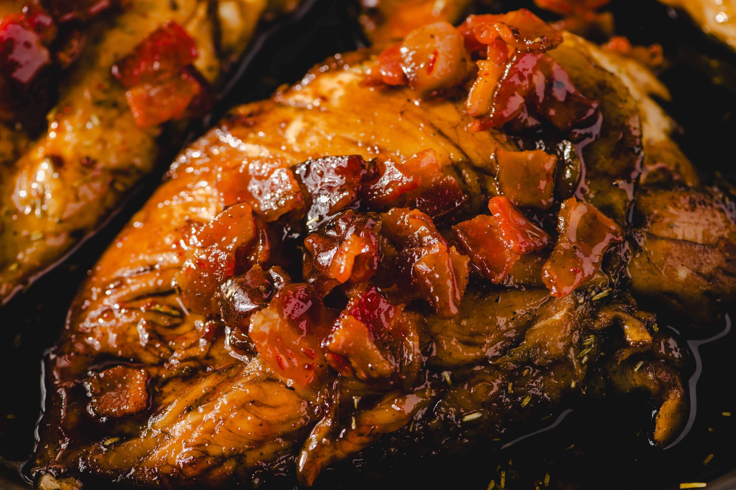 Succulent baked chicken breast topped with rich gravy and crispy bacon, served with a savory sauce and herbs for a flavorful, hearty meal. Perfect for dinner or weekend family gatherings.