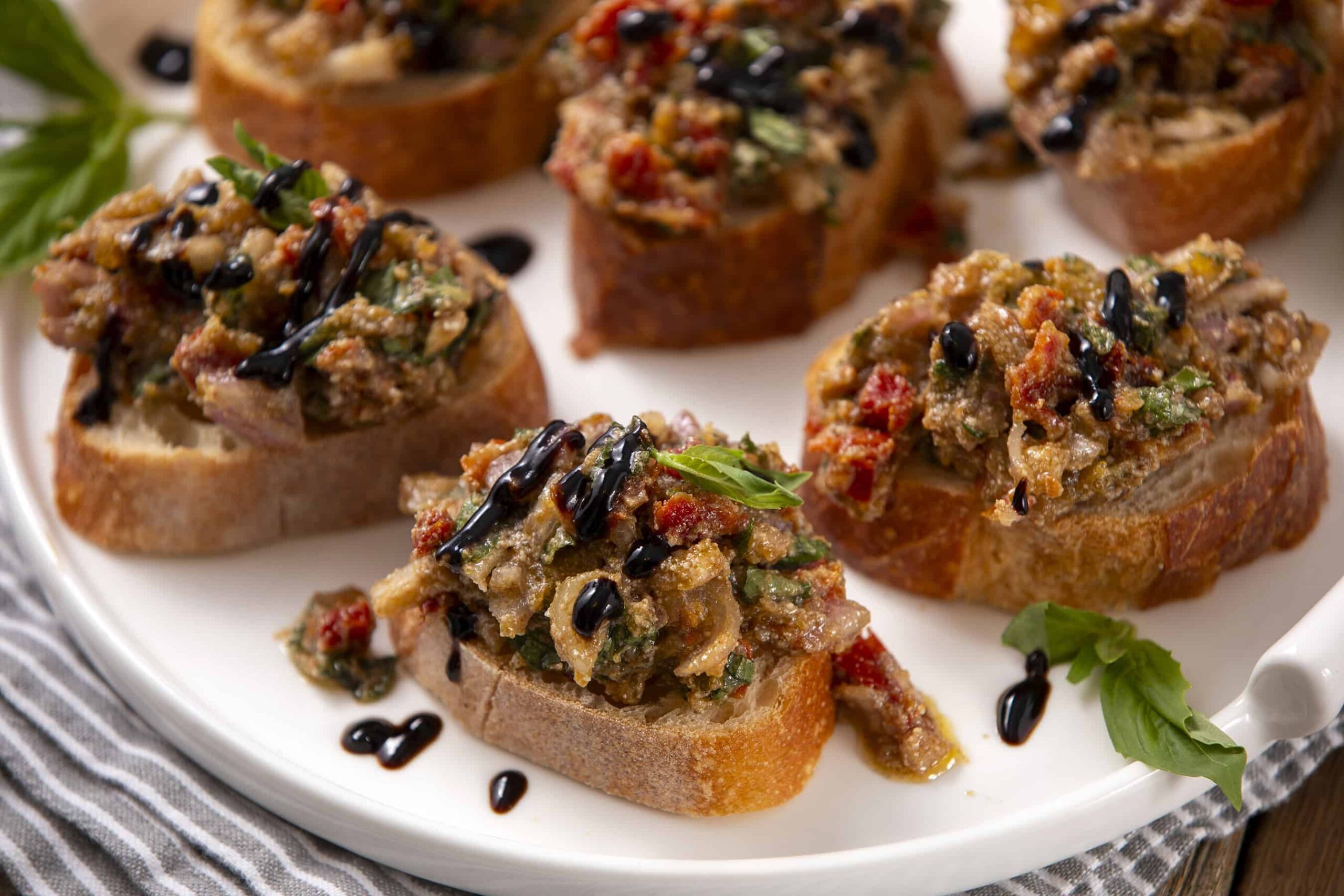 Savory bruschetta topping with chopped vegetables, herbs, and balsamic glaze on toasted bread slices. Perfect appetizer or party snack with fresh ingredients and vibrant flavors.