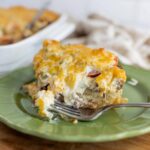 Cheesy breakfast casserole with eggs, cheese, and vegetables on a green plate, ready to serve. Perfect for brunch or family meals, easy baked egg casserole recipe with cheese, eggs, and veggies.