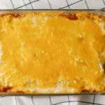 Golden baked cheesy casserole topped with melted cheese in a glass dish.