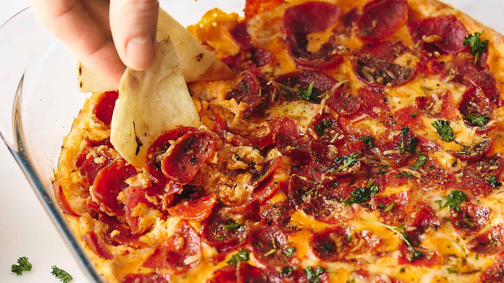 Golden, crispy pizza crust topped with pepperoni, herbs, and melted cheese, ready to be sliced and enjoyed. Perfect for snack or meal, showcasing authentic homemade pizza with fresh ingredients.