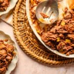 Tender shredded beef with vegetables in a creamy gravy served in a white ceramic baking dish on a rustic woven placemat. Perfect for hearty comfort food and family dinners.