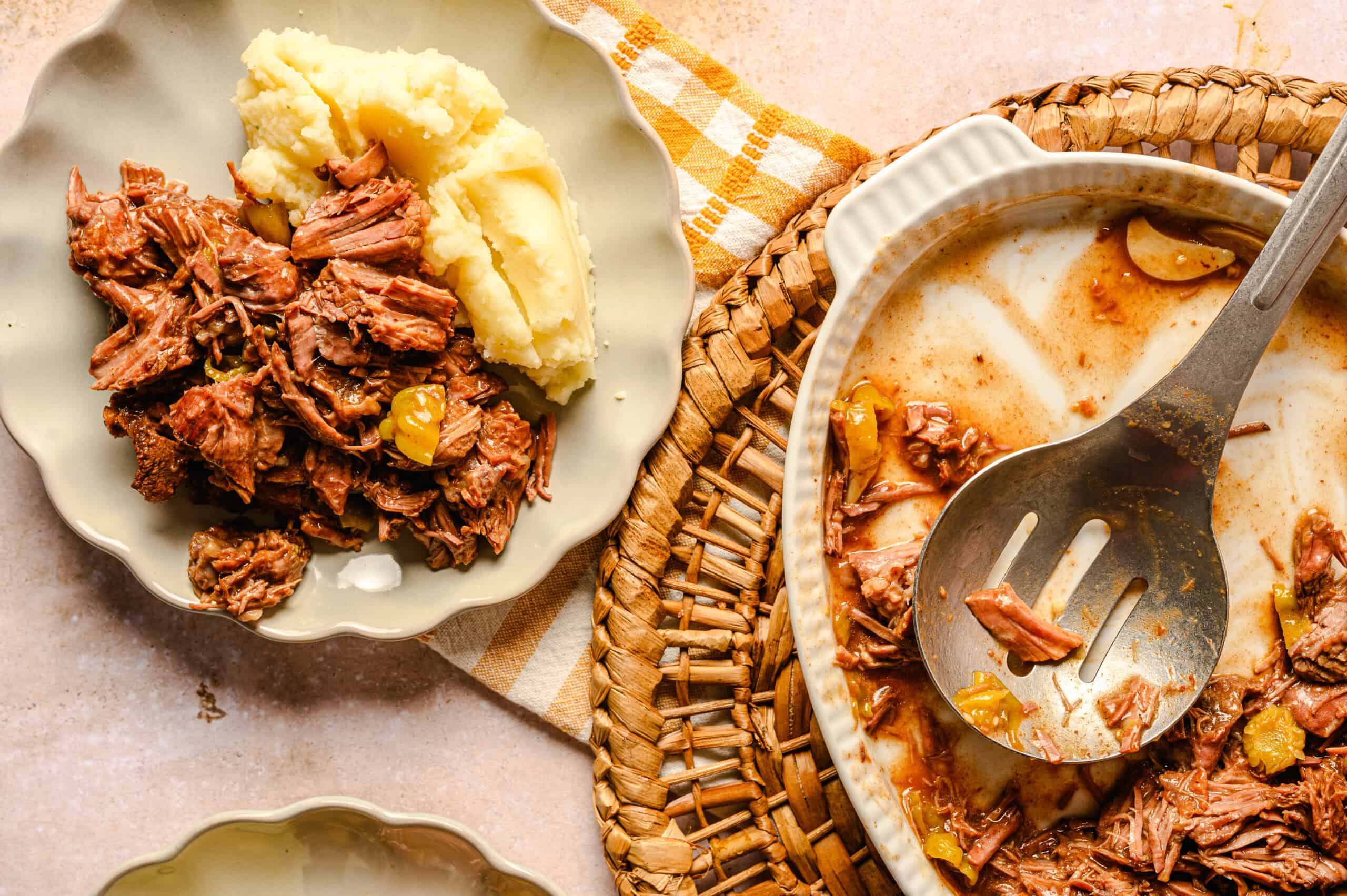 Shredded beef stew with mashed potatoes served on a white plate, close-up image of tender cooked meat with vegetables, hearty comfort food, delicious homemade stew, classic beef recipe, Hey Recipe.