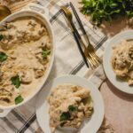 Creamy mushroom and chicken casserole in a baking dish with fresh parsley garnish.
