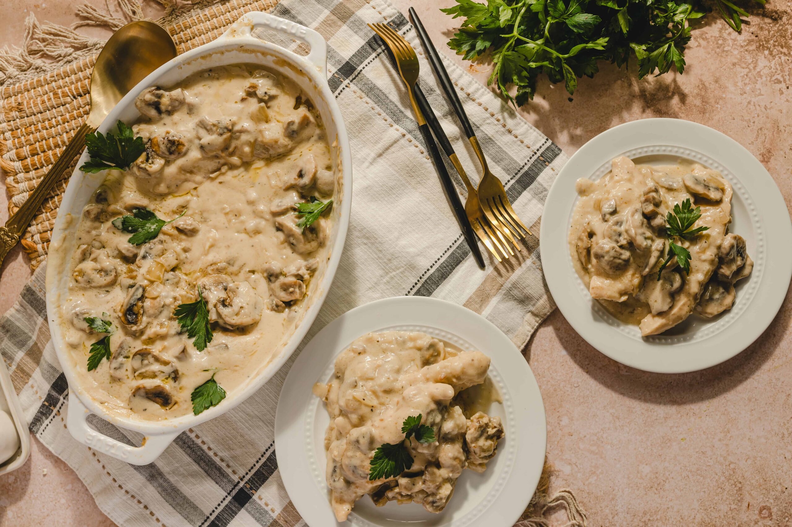 Creamy mushroom and chicken casserole in a baking dish with fresh parsley garnish.