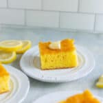 Lemon cake slice with fresh lemon slices and a piece of lemon on top, perfect for lemon desserts and tea time.