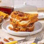 Butterscotch Bread Pudding with Pecans; rich dessert featuring bread soaked in custard topped with butterscotch sauce and pecans, served warm for a delicious treat.