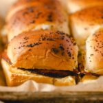 Golden brown dinner rolls with poppy seeds on top, fresh and fluffy, ready to be served with butter or used for sandwiches. Perfect for breakfast or dinner.