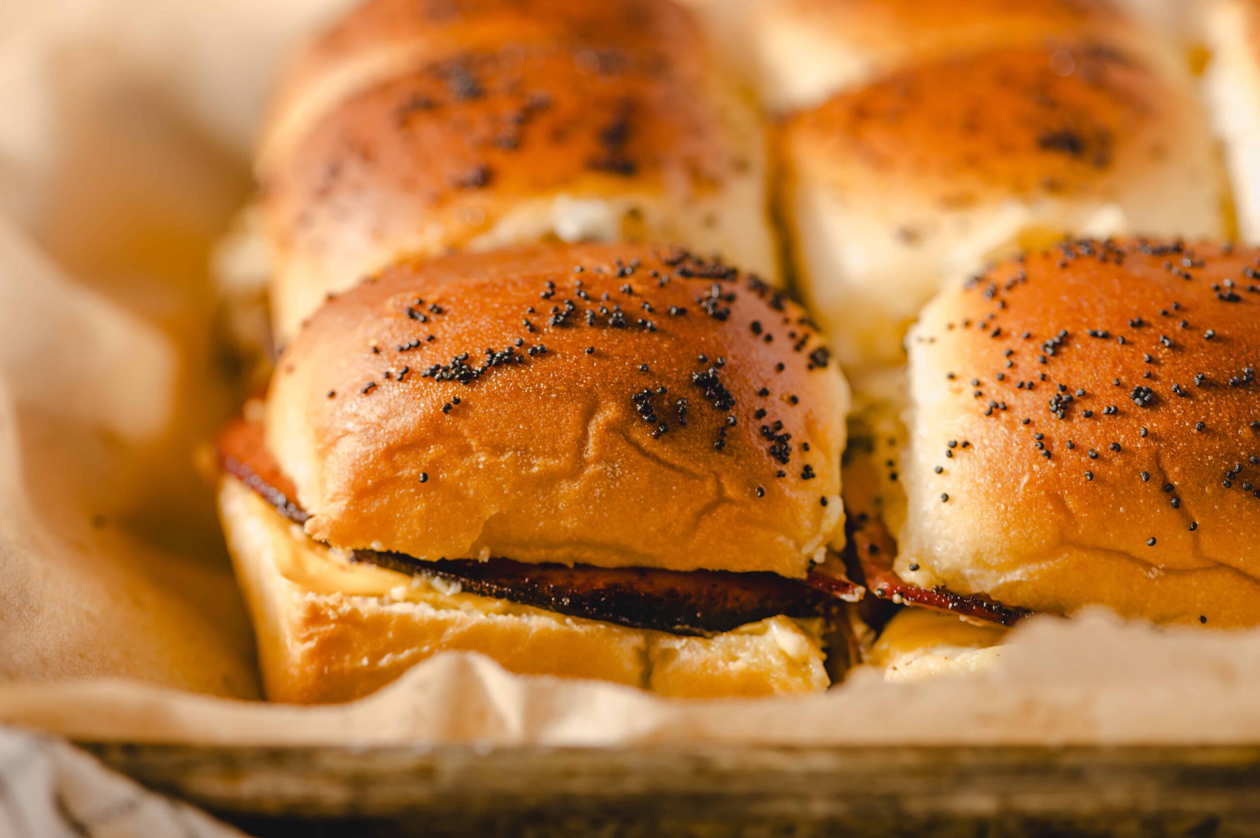 Golden brown dinner rolls with poppy seeds on top, fresh and fluffy, ready to be served with butter or used for sandwiches. Perfect for breakfast or dinner.