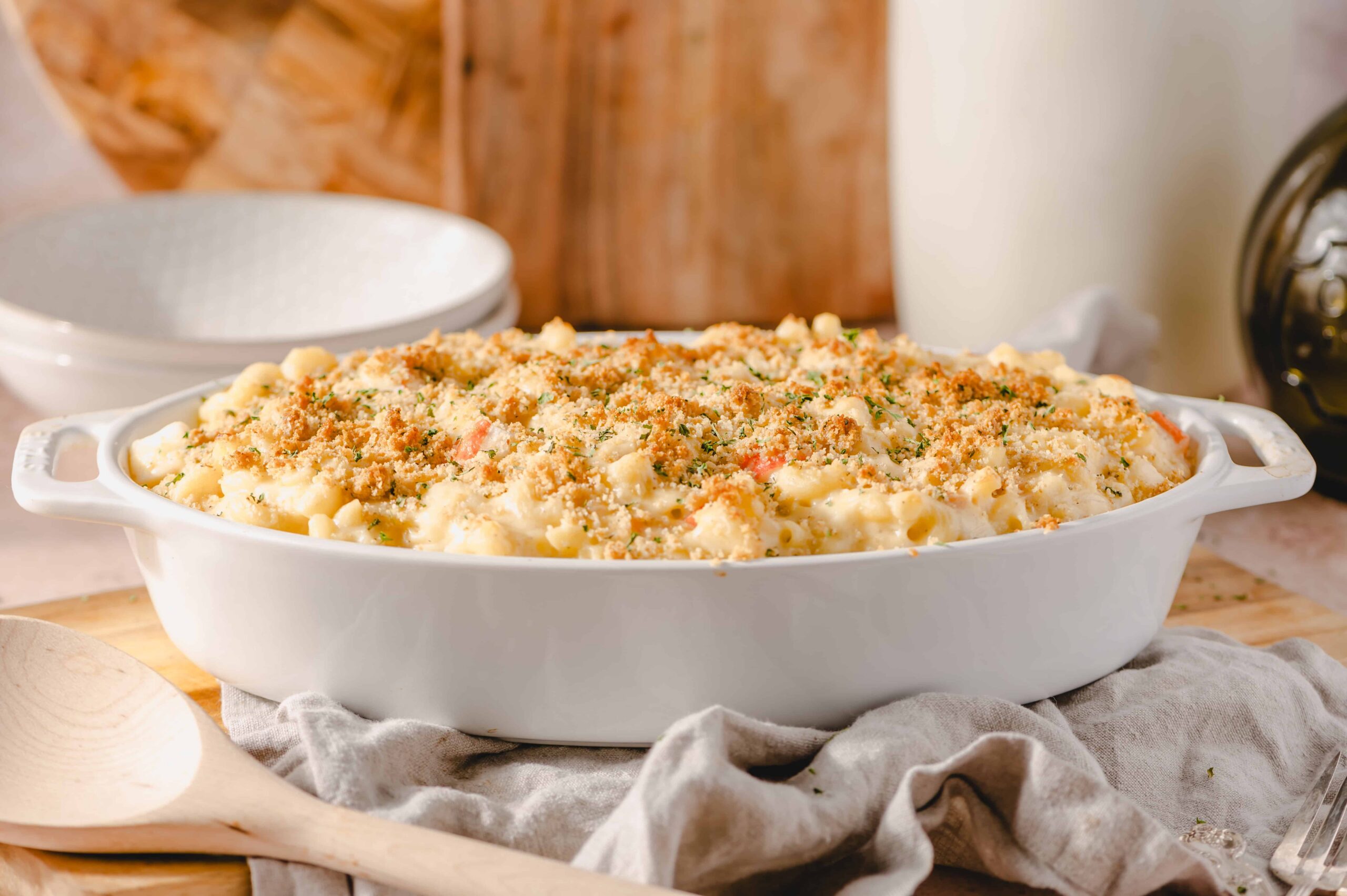 Creamy macaroni and cheese casserole topped with breadcrumbs in a white baking dish. Perfect comfort food, easy to make, and family-friendly classic pasta dish.