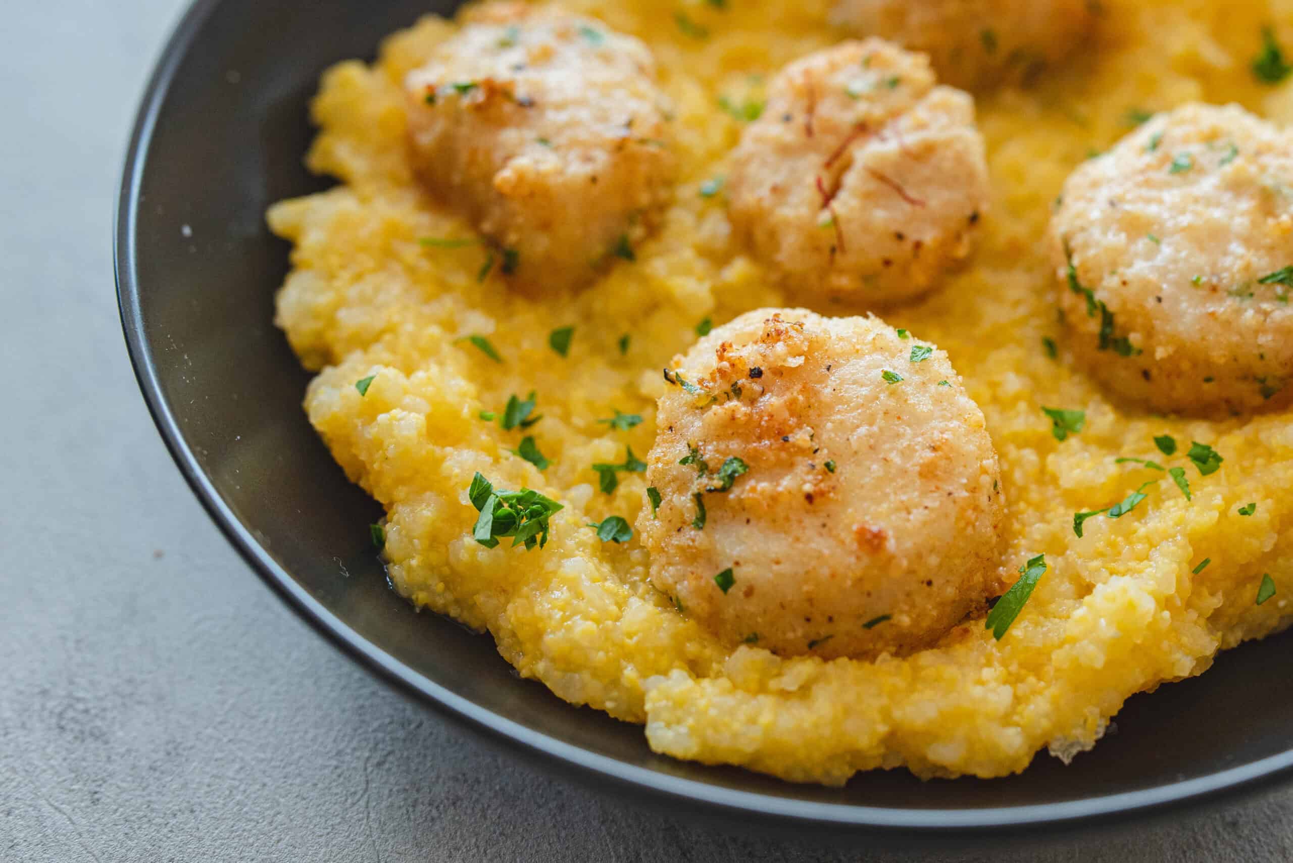 Juicy, seasoned chicken meatballs served over creamy mashed potatoes garnished with chopped parsley. Perfect comfort food dish that combines savory flavors and smooth texture for a satisfying meal.