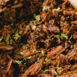Slow-cooked shredded beef with herbs and spices, perfect for tacos, sandwiches, or stews. Tender, flavorful, and ideal for hearty family meals or meal prep.