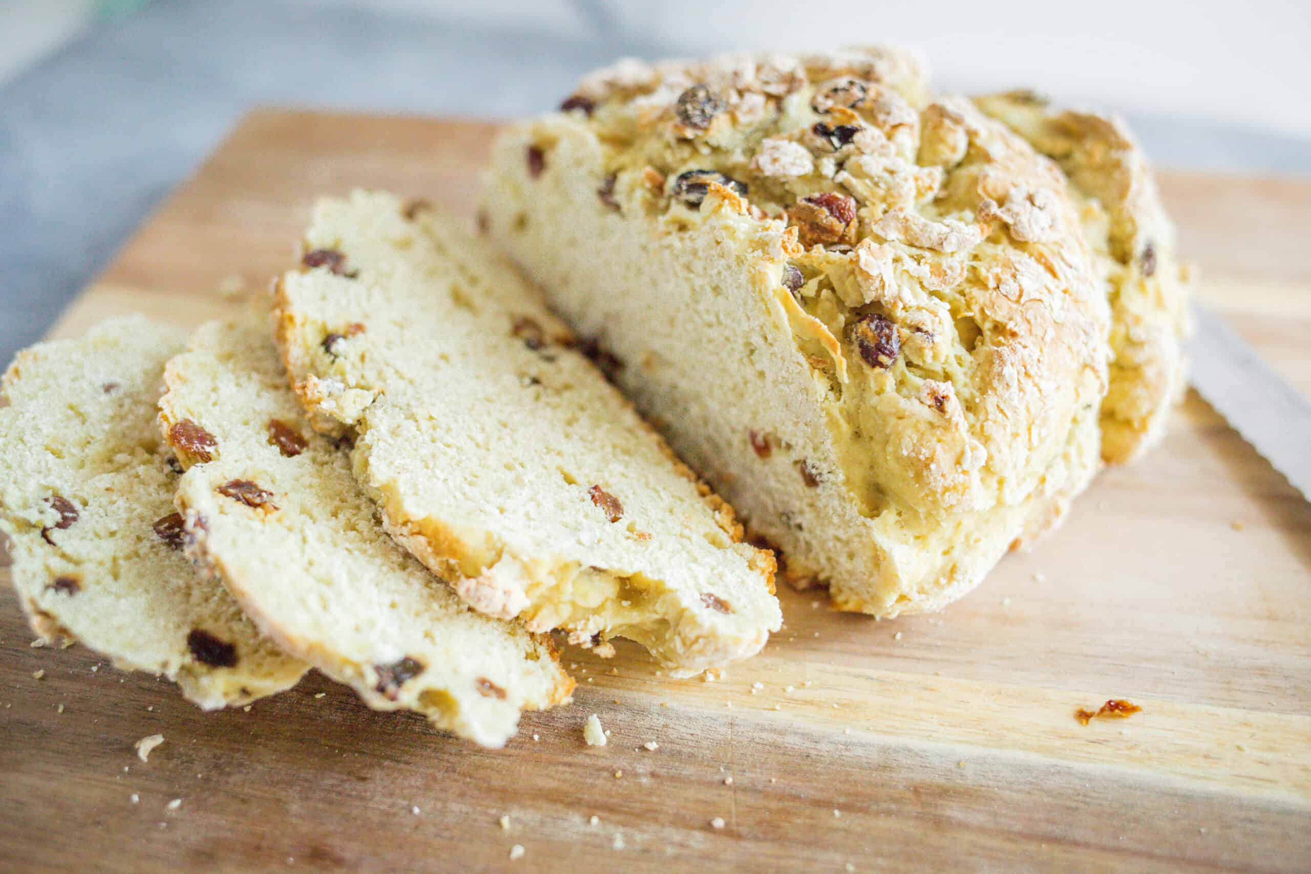 Butter cake with chopped nuts and dried fruits on wooden cutting board, close-up view, homemade dessert, sweet baked good, comforting treat, delicious homemade cake, ingredient-focused photo, appealing bakery-style treat, perfect for snack or celebration, cozy baking at home.